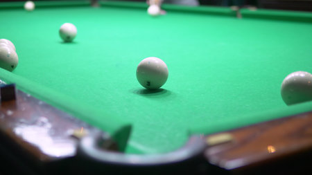 billiards. Close-up. man hand with cue and white ball on a green pool table. copy space.
