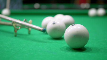 billiards. Close-up. man hand with cue and white ball on a green pool table. copy space.