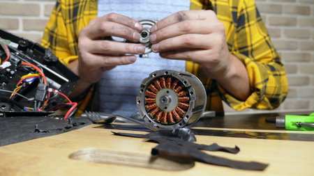 mechanic repairing an electric motor of an electric skate. bearing close up.