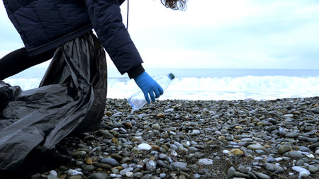 volunteers clean up trash on the beach in the fall. environmental issuesの写真素材