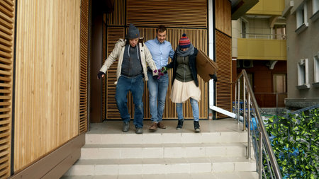a guard throws a homeless man and woman from a fashionable porch