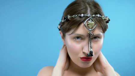 the girl wears a head black agate beads with a pendant in the shape of a heart