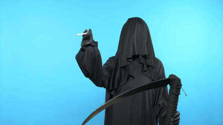 Sketch on a blue background. death with a scythe shows a cigaretteの写真素材