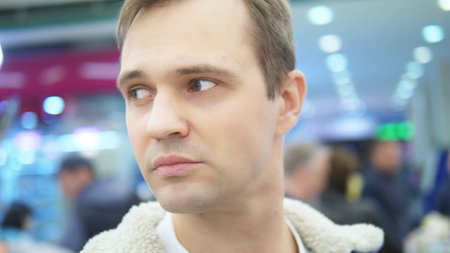 closeup. portrait of tired man in the supermarket. looking around