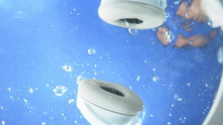 blurred background. The man threw the headphones under the waterの写真素材