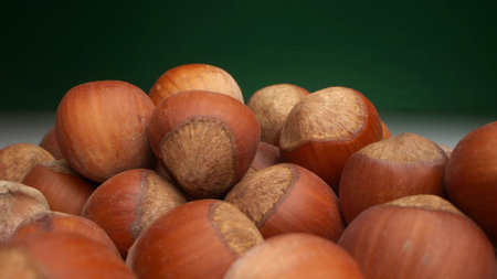 extremely close-up, detailed. many hazelnuts on a dark backgroundの写真素材