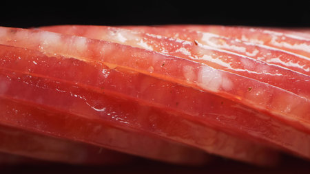 extreme closeup, detailed. salami sausage cut into thin pieces on a wooden boardの写真素材