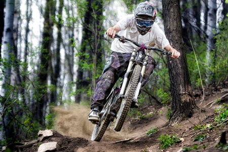 Mountainbiker rides on path in forestのeditorial素材