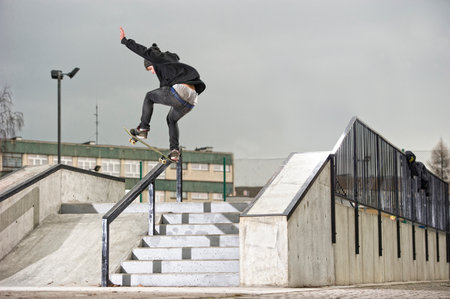 Boy doing skateboard trick on rail