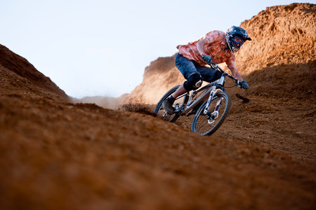Mountainbiker rides in gorge on desertの写真素材