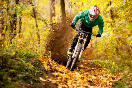 Mountainbiker rides in autumn forestのeditorial素材