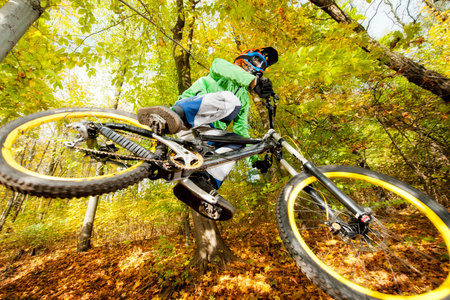 Mountainbiker rides in autumn forestのeditorial素材