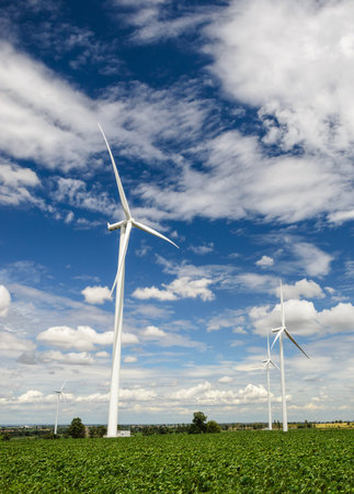 Wind turbines produce electricity Alternative energy with sky and cloud backgroundの写真素材