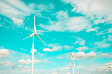 Wind turbines produce electricity Alternative energy with sky and cloud backgroundの写真素材