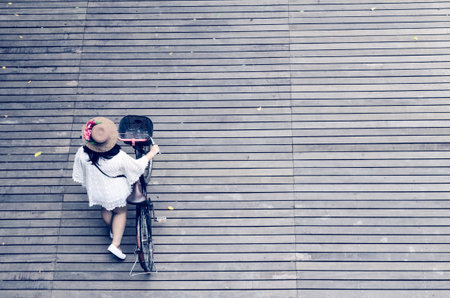 women and bicycle on the wooden floor vintage filterの写真素材