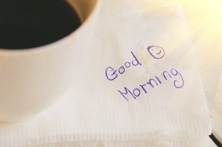 handwriting on a napkin with a cup of coffee and emoticon smiling face