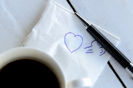 A cup of Coffee and pen with wordの写真素材