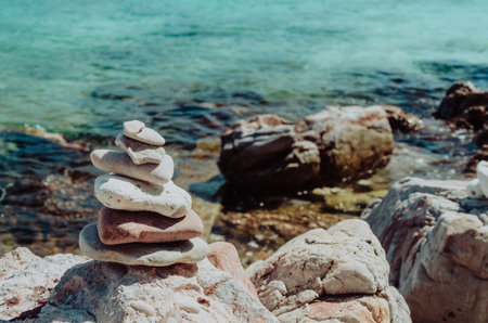Pyramid of pebbles on the seashore. Zen conceptの写真素材