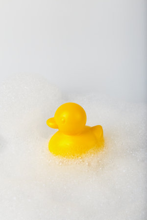 Minimalistic concept toy duck in the foam. bathing childrenの写真素材