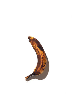 Spoiled banana on a white background. minimalismの写真素材