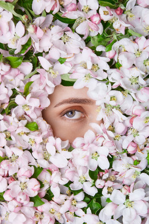 a pattern of flowers with a female eye located in the center. Beauty template, place for an inscription. template for advertisingの写真素材