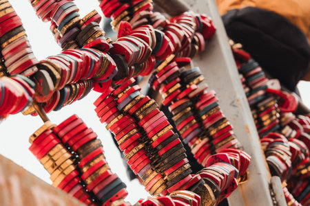 Close up of numerous colorful love padlocks attached to a metal framework. Popular romantic tradition representing affection, commitment, marriage, partnership and lasting relationships, captured with shallow depth of field and vibrant details.