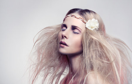 Beautiful woman with a flowerの写真素材