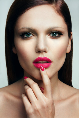 Portrait of beautiful girl with pink lips and blue eyesの写真素材