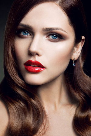 Portrait of beautiful girl with red lips and blue eyesの写真素材