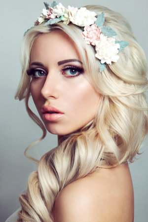 Beautiful lady with a wreath of flowers. Pink rosesの写真素材