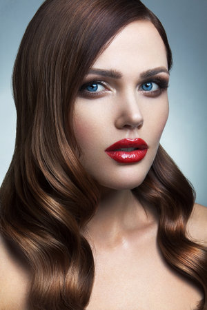 Portrait of beautiful girl with red lips and blue eyesの写真素材