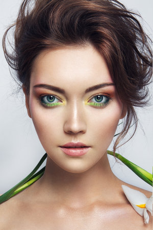 Close-up studio portrait of beautiful woman with bright make-upの写真素材