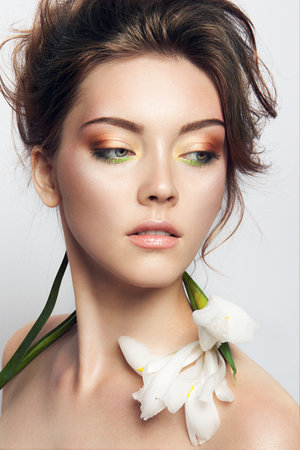 Close-up studio portrait of beautiful woman with bright make-upの写真素材