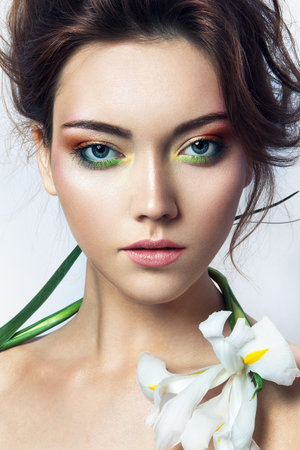 Close-up studio portrait of beautiful woman with bright make-upの写真素材