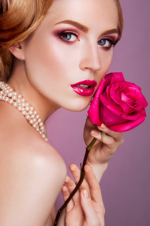 Lady with pink rose の写真素材