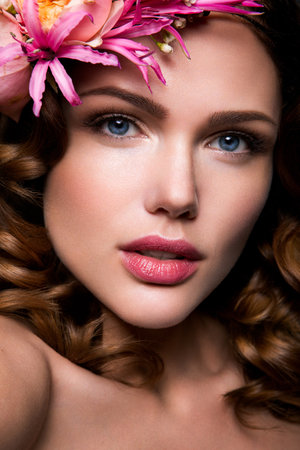 Beautiful lady with a wreath of pink flowersの写真素材
