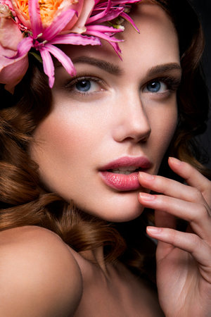 Beautiful lady with a wreath of pink flowersの写真素材