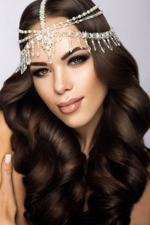 Beautiful bride with wedding makeup and hairstyle, attractive newlywed woman have final preparation for wedding. Bride waiting groom. Happy newlywed. Marriage. Wedding day moments. Bride makeup.の写真素材