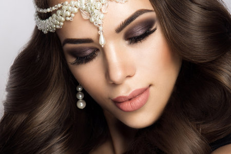 Beautiful bride with wedding makeup and hairstyle, attractive newlywed woman have final preparation for wedding. Bride waiting groom. Happy newlywed. Marriage. Wedding day moments. Bride makeup.の写真素材