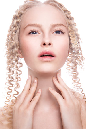 Portrait of a beautiful woman with curly blonde hair on white backgroundの写真素材