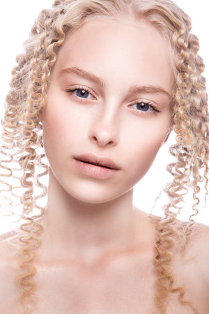 Portrait of a beautiful woman with curly blonde hair on white backgroundの写真素材
