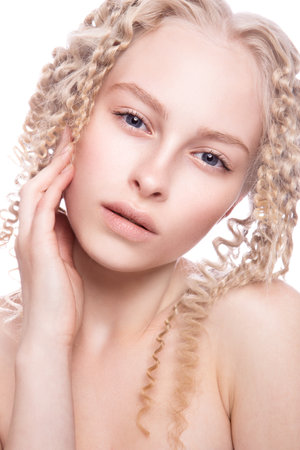 Portrait of a beautiful woman with curly blonde hair on white backgroundの写真素材