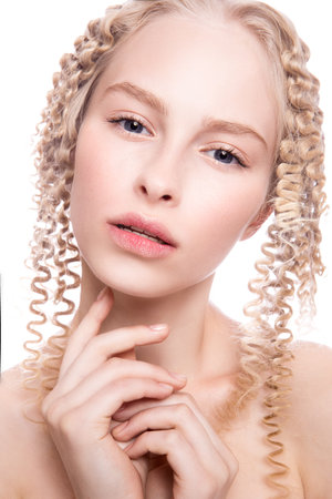 Portrait of a beautiful woman with curly blonde hair on white backgroundの写真素材