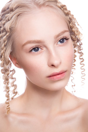 Portrait of a beautiful woman with curly blonde hair on white backgroundの写真素材