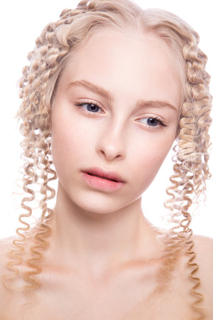 Portrait of a beautiful woman with curly blonde hair on white backgroundの写真素材