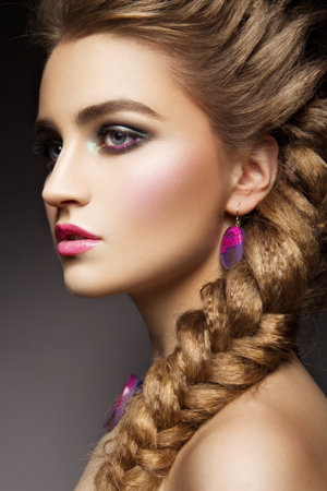 Close-up portrait of beautiful woman with bright make-up and pink lipsの写真素材