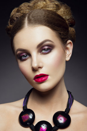 Close-up portrait of beautiful woman with bright make-up and pink lipsの写真素材