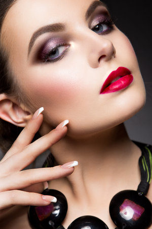 Close-up portrait of beautiful woman with bright make-up and pink lipsの写真素材