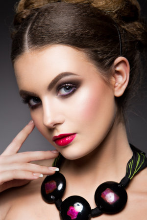 Close-up portrait of beautiful woman with bright make-up and pink lipsの写真素材