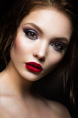 Beautiful young model with red lips and dark makeapの写真素材
